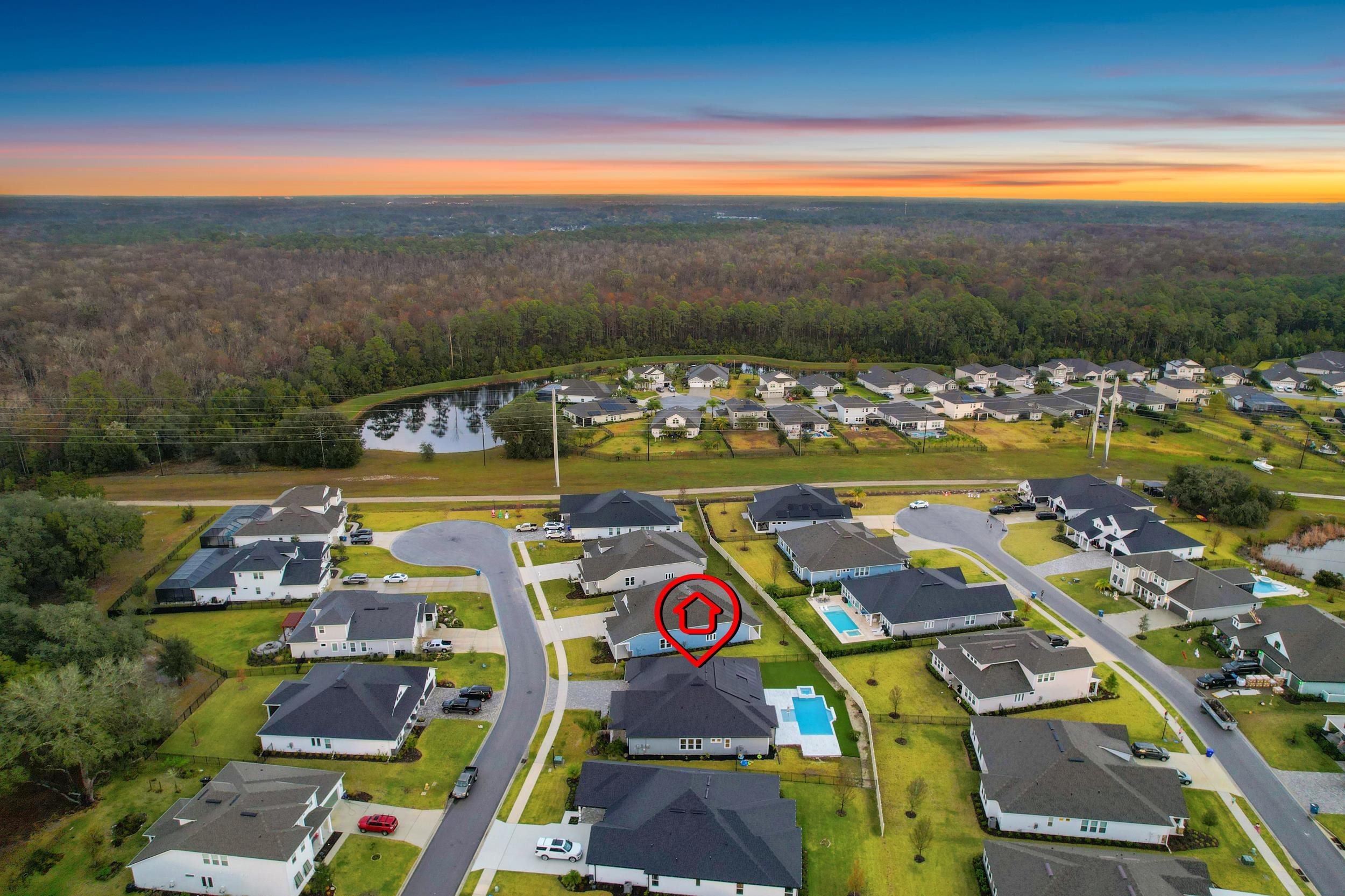 64 Oak Cluster Lane St. Augustine, FL 32092 - Photo 53 of 59 Aerial view at dusk of a residential view, a wooded view, and a water view
