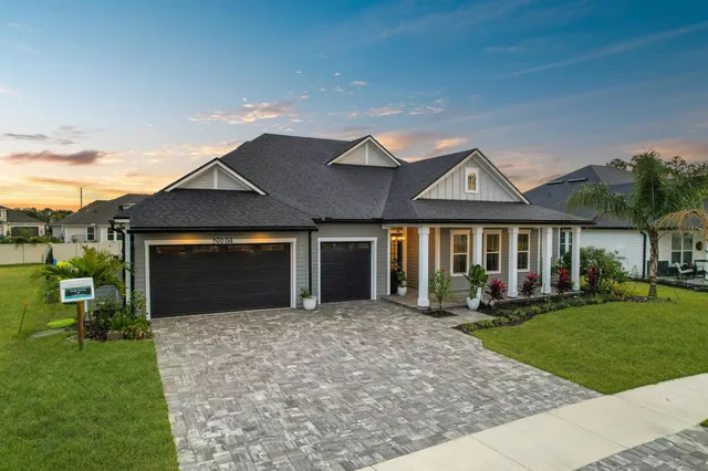 a front view of a house with a yard and porch