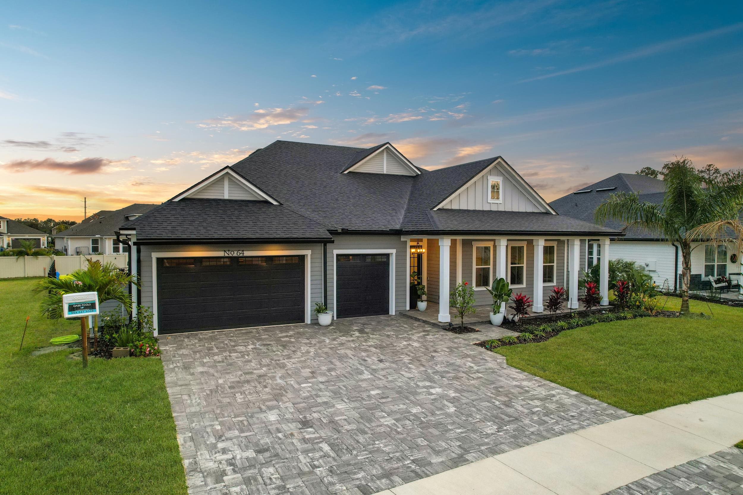 64 Oak Cluster Lane St. Augustine, FL 32092 - Photo 6 of 59 a front view of a house with a yard and porch