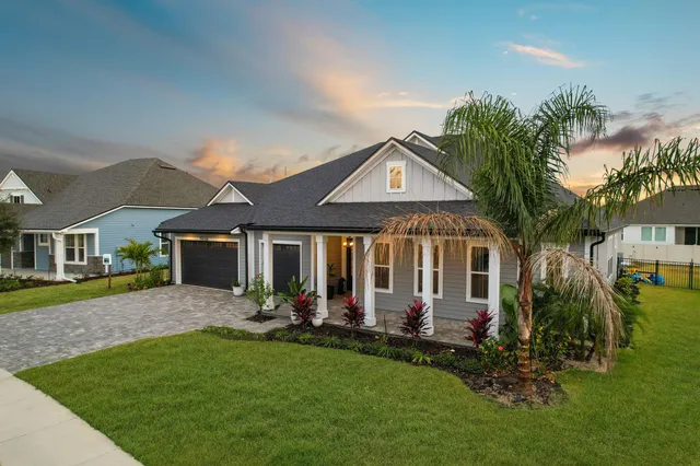 a front view of a house with a garden and porch