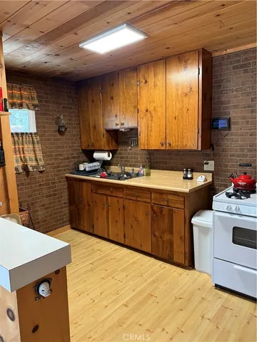 a kitchen with a sink cabinets and window