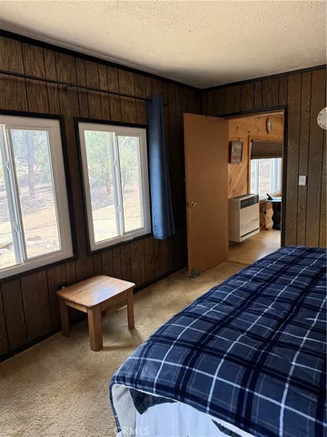 a bedroom with a bed and a large window