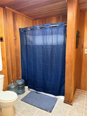 a bathroom with a toilet and a shower