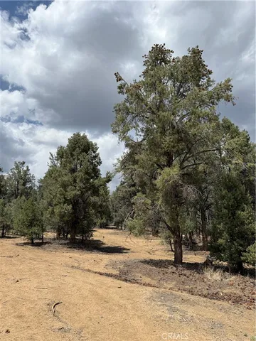 a view of a house with a yard covered with snow in the background