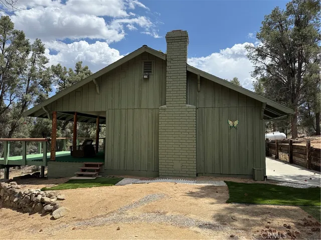 a backyard of a house with barbeque oven fire pit and outdoor seating
