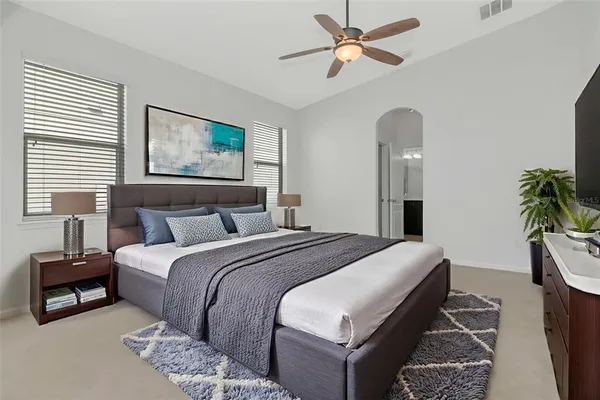 a bedroom with a bed and a chandelier