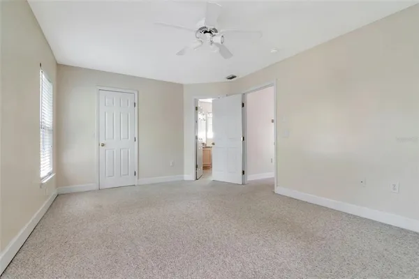 a view of an empty room with a ceiling fan