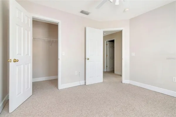 an empty room with closet and a bathroom