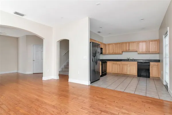 a view of kitchen with wooden floor and electronic appliances