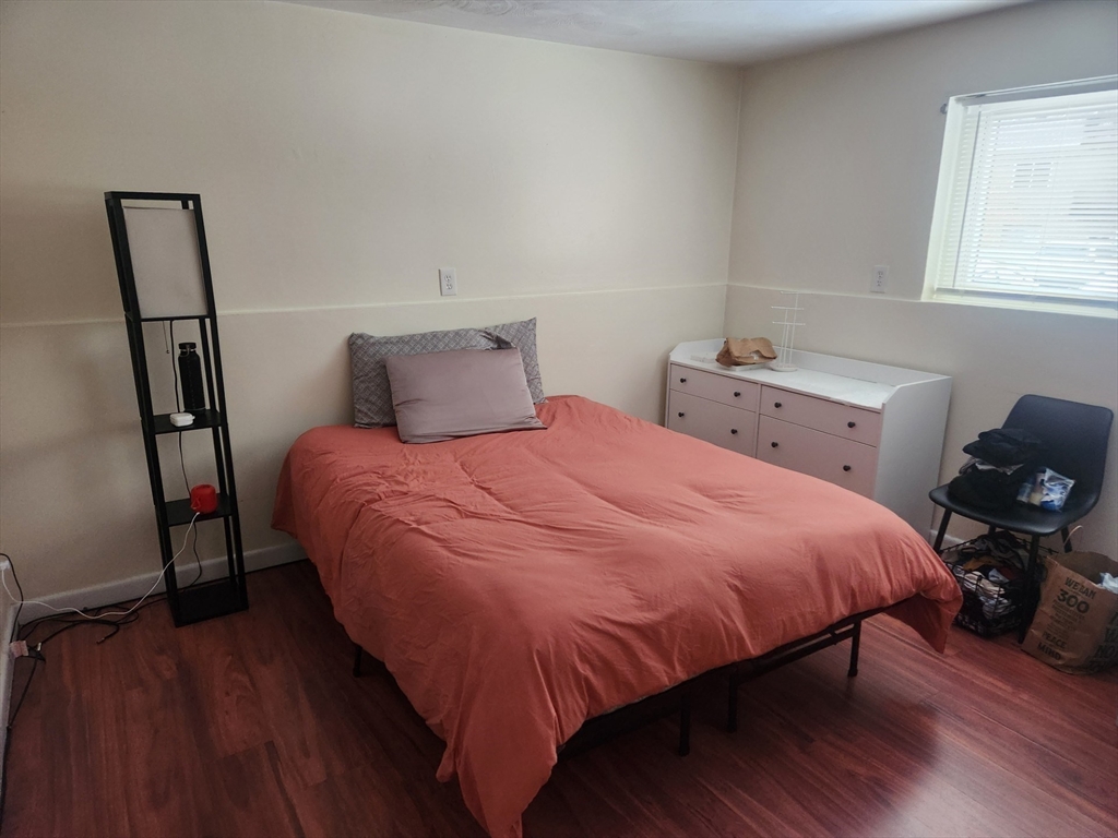 176 Maple Avenue, Unit 22 Rutland, MA 01543 - Photo 6 of 9 a bedroom with a bed and wooden floor