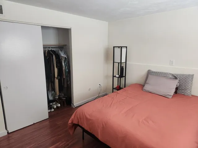 a bedroom with a bed and a mirror