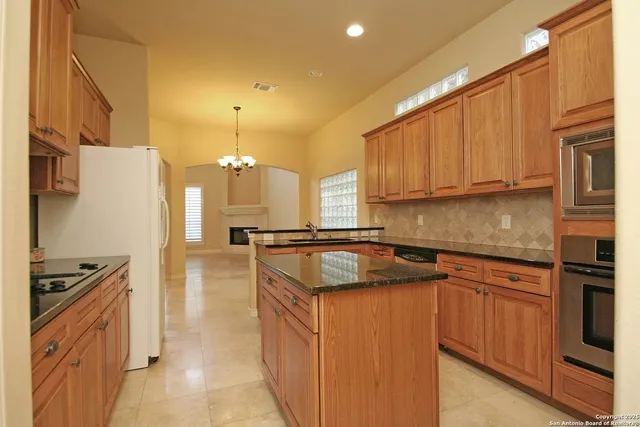 a kitchen with a sink appliances and cabinets