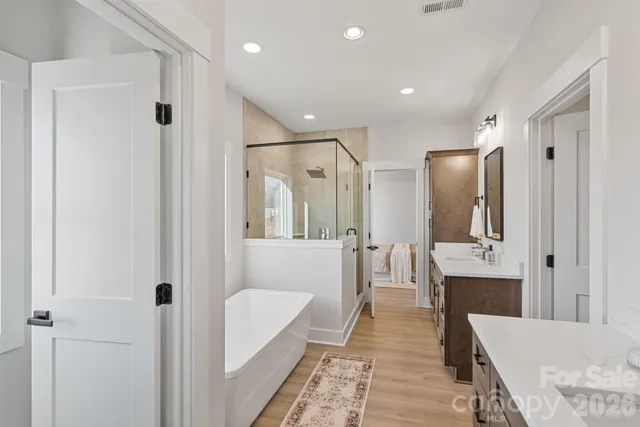 a bathroom with a tub shower and sink