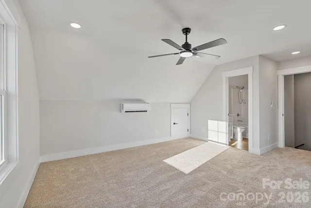 a view of a livingroom with a ceiling fan and window