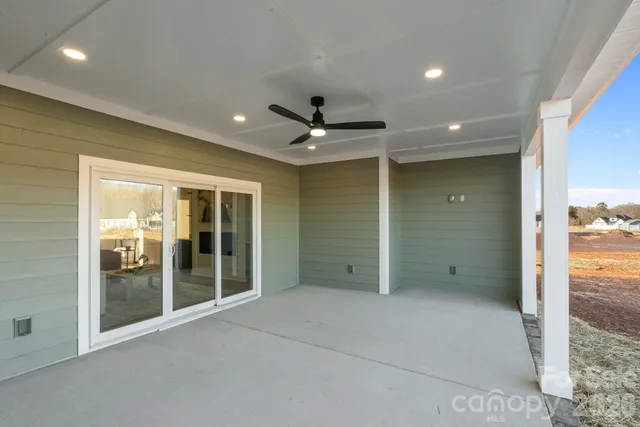 a view of an empty room with a ceiling fan