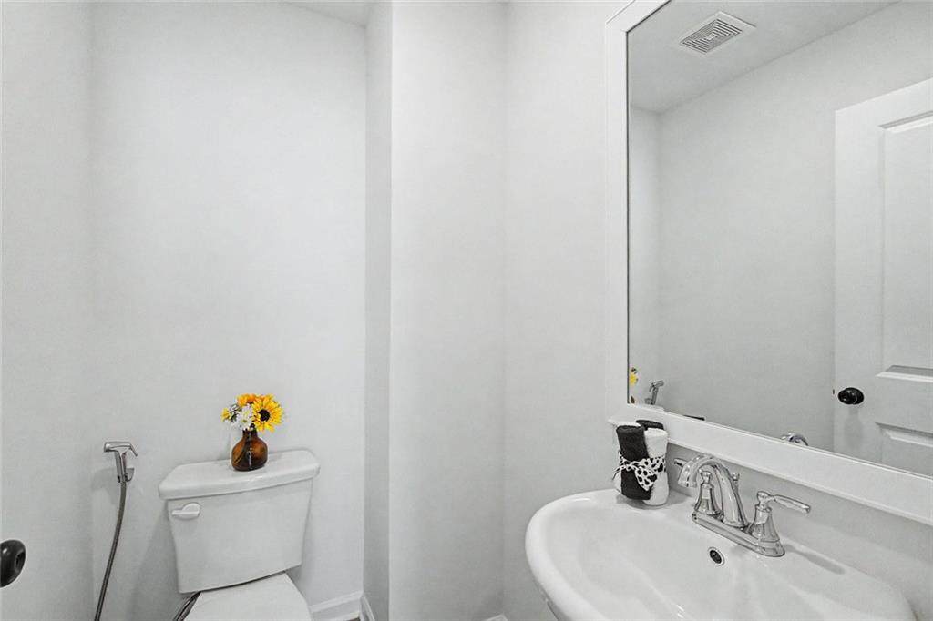2310 Portrush Way Southeast Atlanta, GA 30339 - Photo 21 of 38 a bathroom with a sink a toilet and a mirror