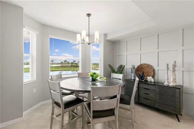 a dining room with furniture and chandelier
