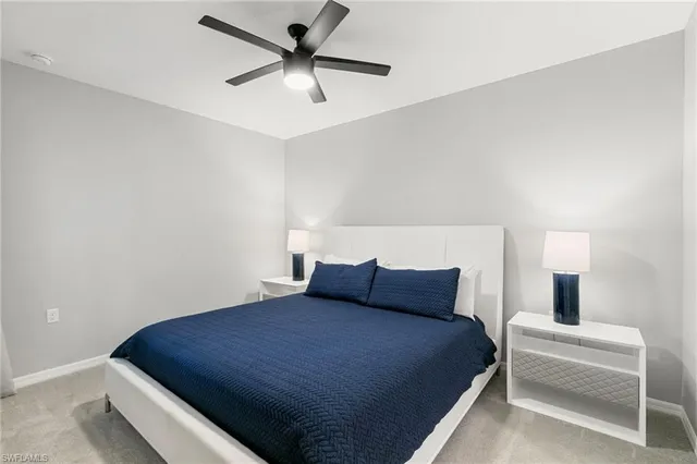 a bedroom with a bed and a ceiling fan