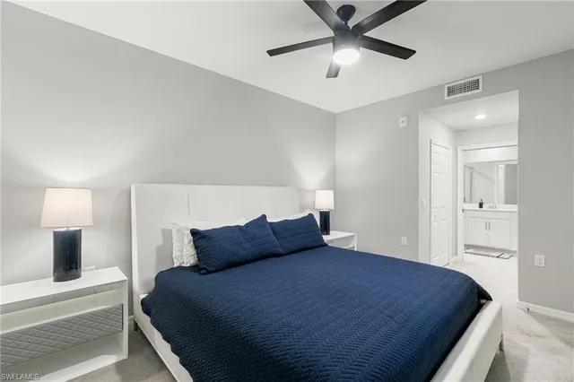 a bedroom with a bed and a ceiling fan