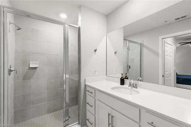 a bathroom with a shower sink and mirror