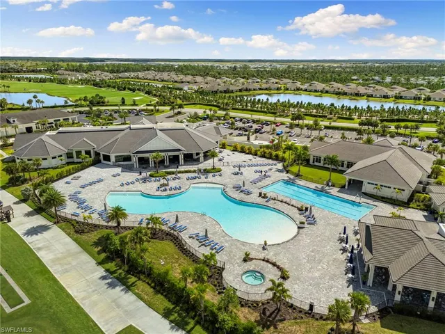 an aerial view of residential houses with outdoor space and river