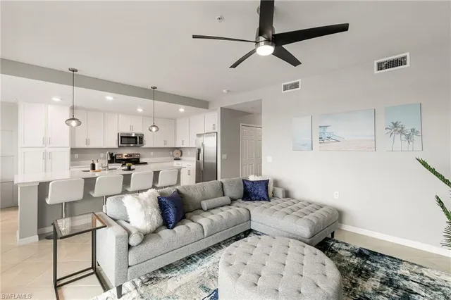 a living room with furniture and kitchen view