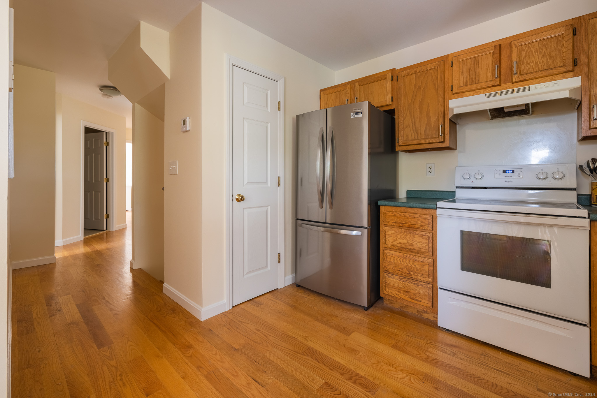 916 Reef Road Fairfield, CT 06824 - Photo 13 of 16 a kitchen with granite countertop a refrigerator stove and oven