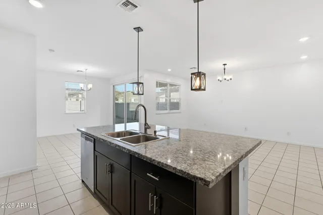 a kitchen with stainless steel appliances granite countertop a sink a counter top space and cabinets