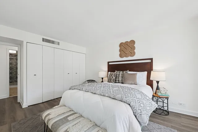 a bedroom with a bed and wooden floor