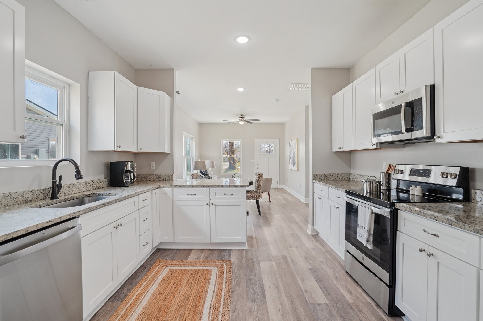 152 Eno Road Dickson, TN 37055 - Photo 13 of 35 a kitchen with stainless steel appliances granite countertop a sink and stove top oven