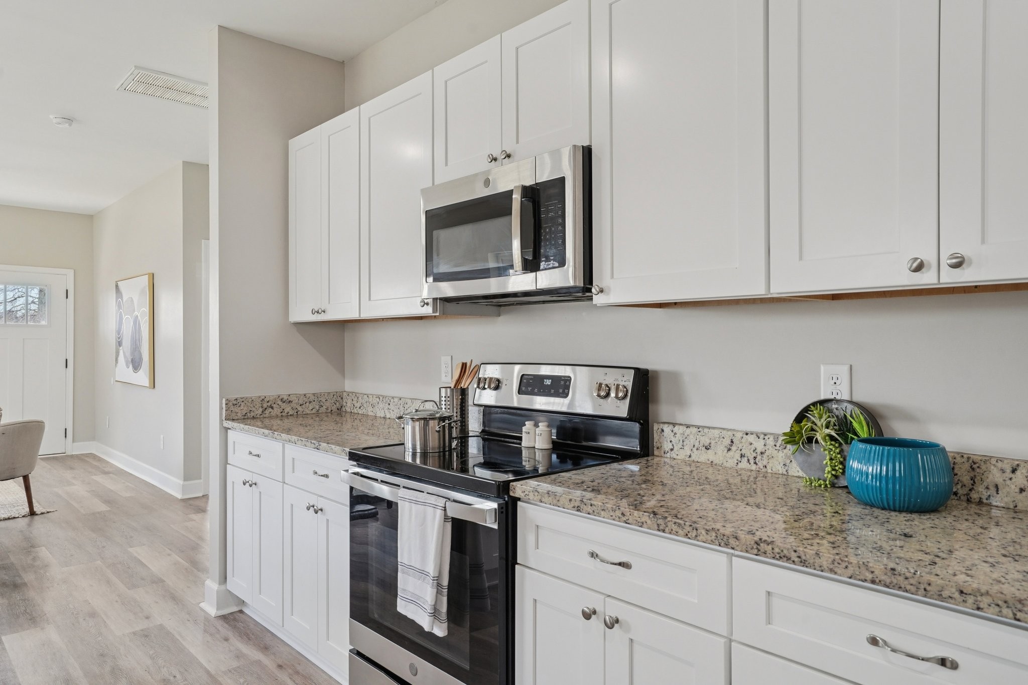 152 Eno Road Dickson, TN 37055 - Photo 16 of 35 a kitchen with stainless steel appliances granite countertop white cabinets a stove a sink and dishwasher