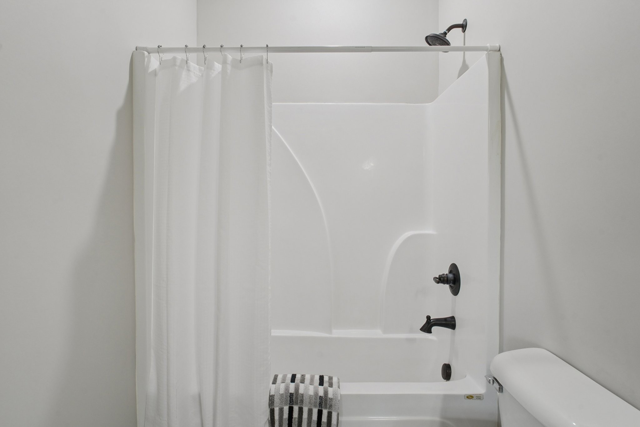 152 Eno Road Dickson, TN 37055 - Photo 25 of 35 a bathroom with a shower curtain and a toilet