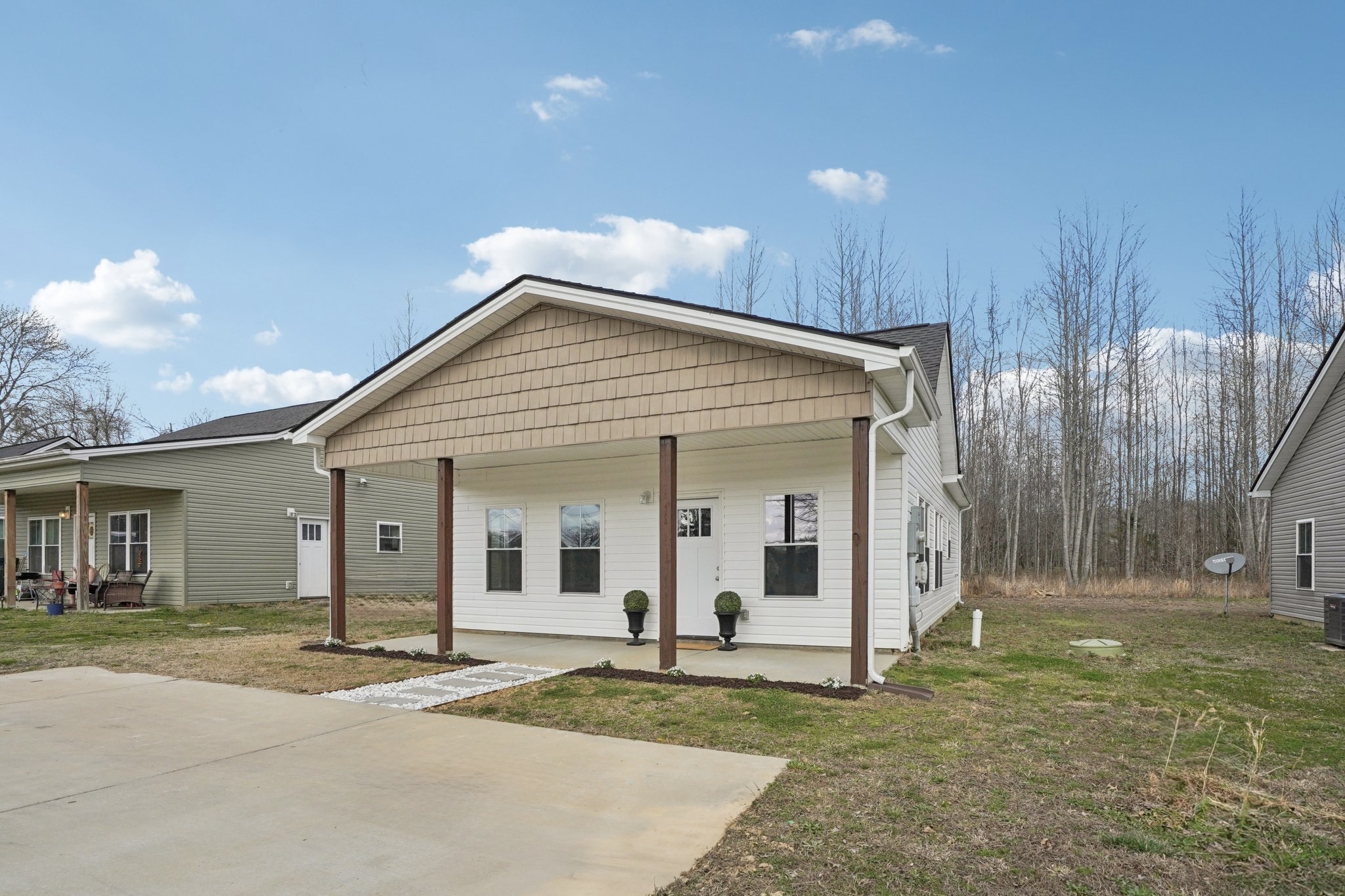 152 Eno Road Dickson, TN 37055 - Photo 9 of 35 a view of a white house with a yard and large tree