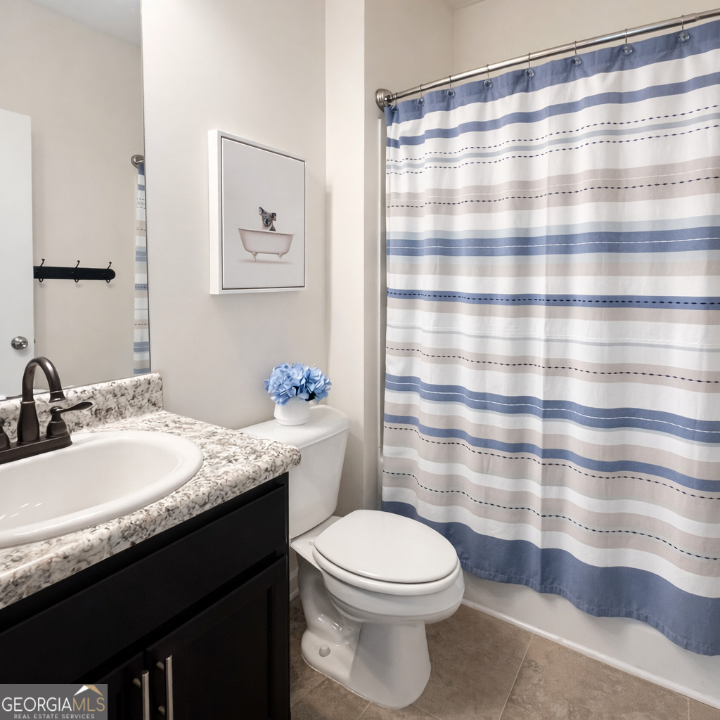78 Willowrun Drive Rome, GA 30165 - Photo 23 of 35 a bathroom with a granite countertop sink a toilet a mirror and shower curtain