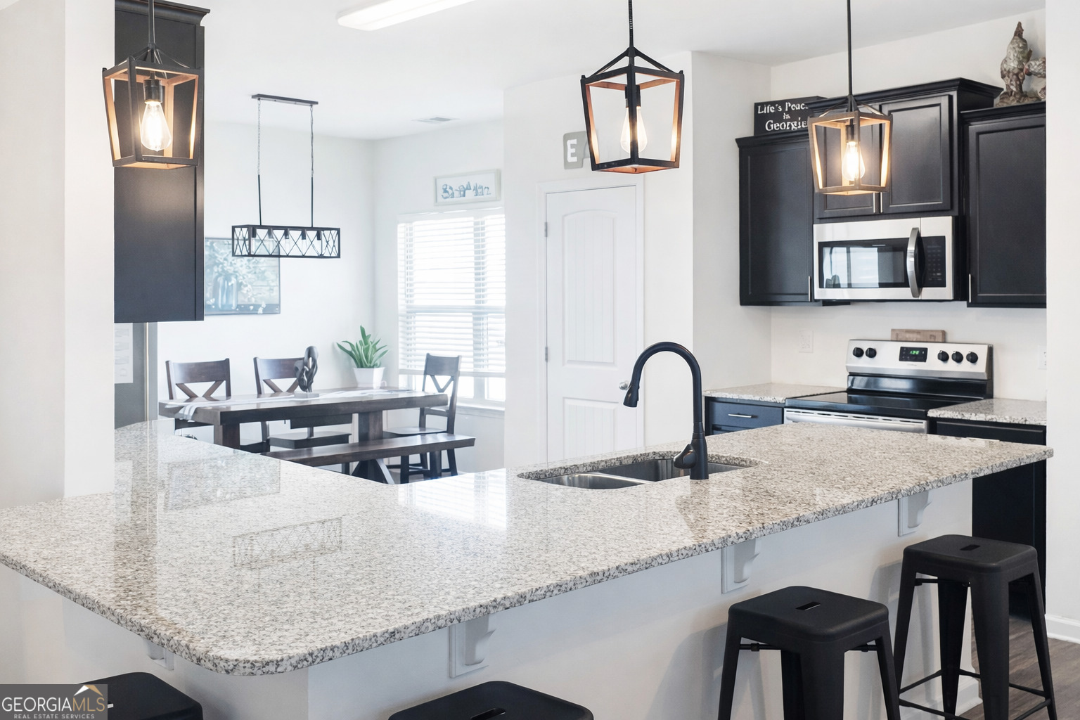 78 Willowrun Drive Rome, GA 30165 - Photo 5 of 35 a kitchen with granite countertop a table chairs stove and refrigerator
