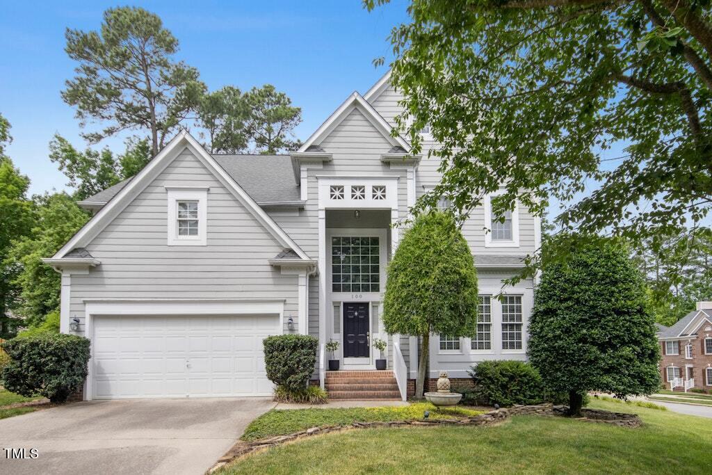 a front view of a house with a garden and plants