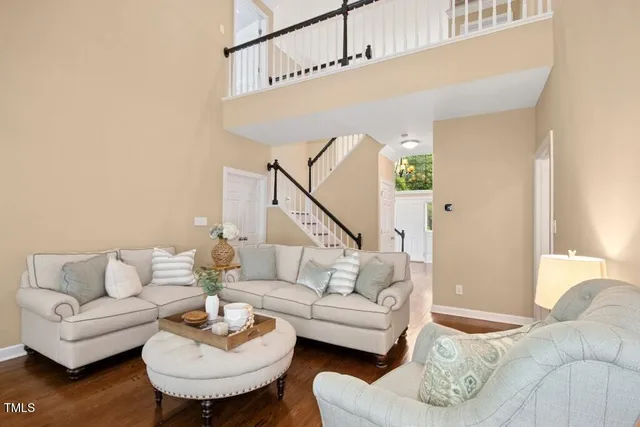 a kitchen with stainless steel appliances granite countertop a stove a sink dishwasher and a dining table with wooden floor