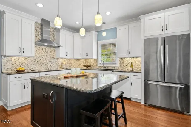 a view of a dining room with furniture wooden floor and chandelier