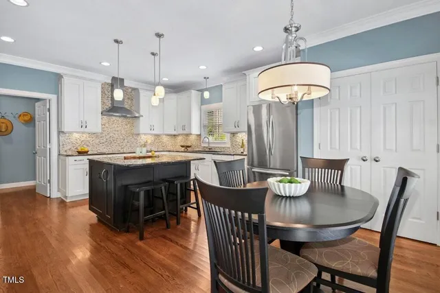 a kitchen with sink cabinets and dining table