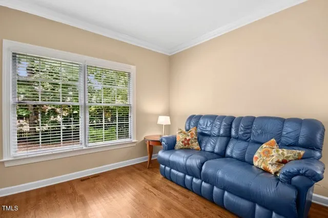 a view of a hallway with wooden floor and stairs