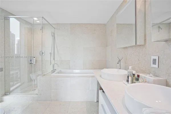 a bathroom with a bathtub a sink a toilet and a shower