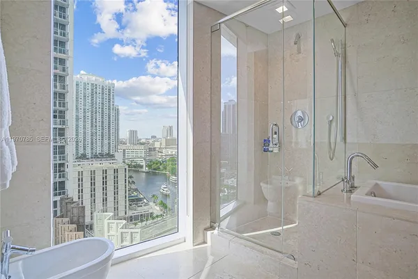 a bathroom with a shower and a sink