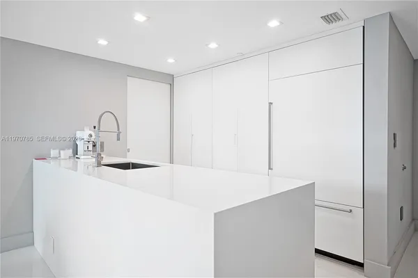 a kitchen with stainless steel appliances a sink and a refrigerator