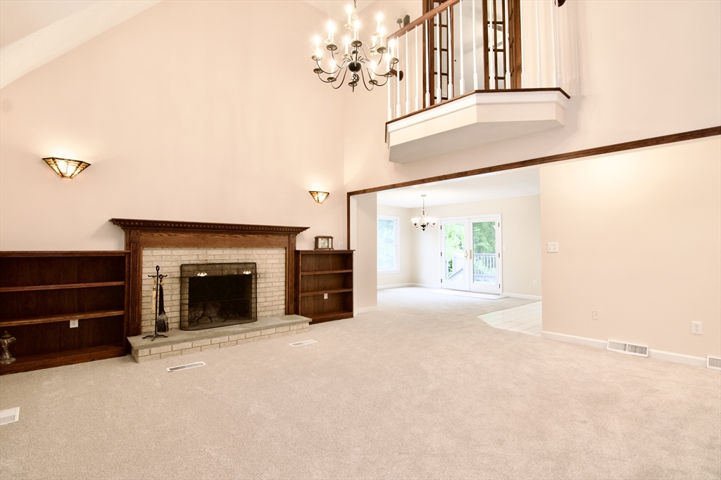 97 Monson Road Brimfield, MA 01010 - Photo 11 of 42 a view of an empty room with a fireplace and a window