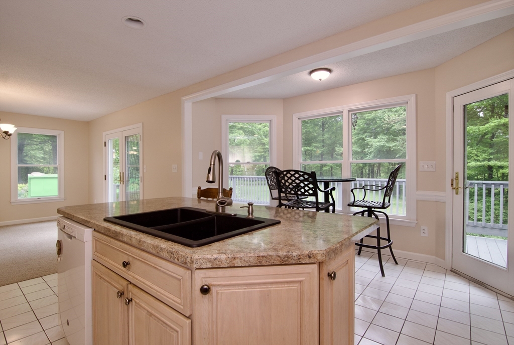 97 Monson Road Brimfield, MA 01010 - Photo 21 of 42 a kitchen with a stove a table and chairs in it