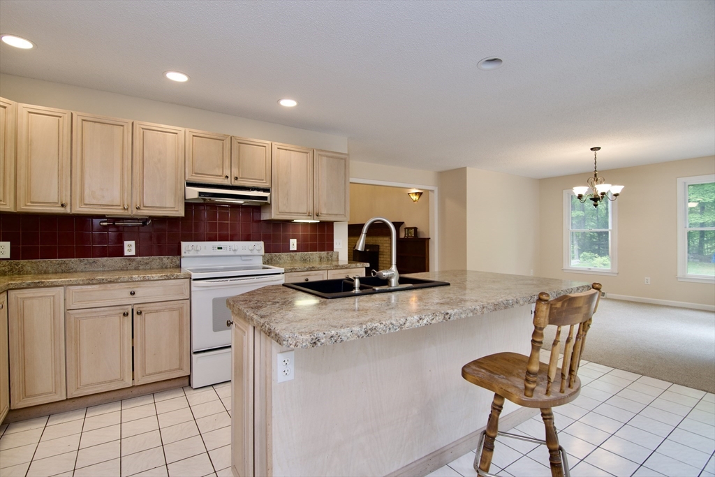 97 Monson Road Brimfield, MA 01010 - Photo 25 of 42 a kitchen with a stove a sink and a refrigerator