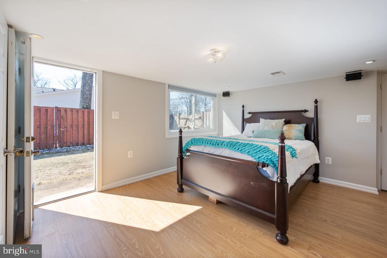 2405 Cedar Lane Vienna, VA 22180 - Photo 16 of 56 a bedroom with a bed and wooden floor