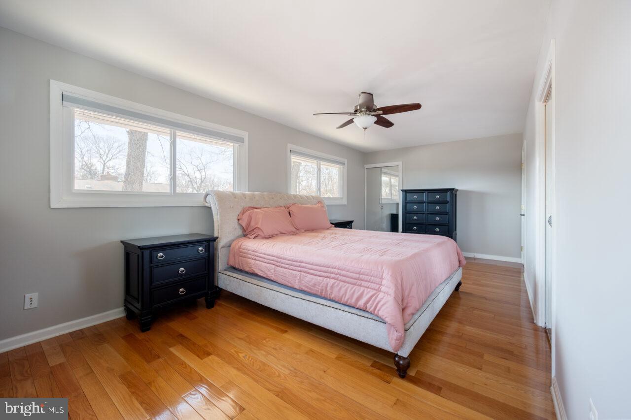 2405 Cedar Lane Vienna, VA 22180 - Photo 27 of 56 a spacious bedroom with a bed and a chandelier