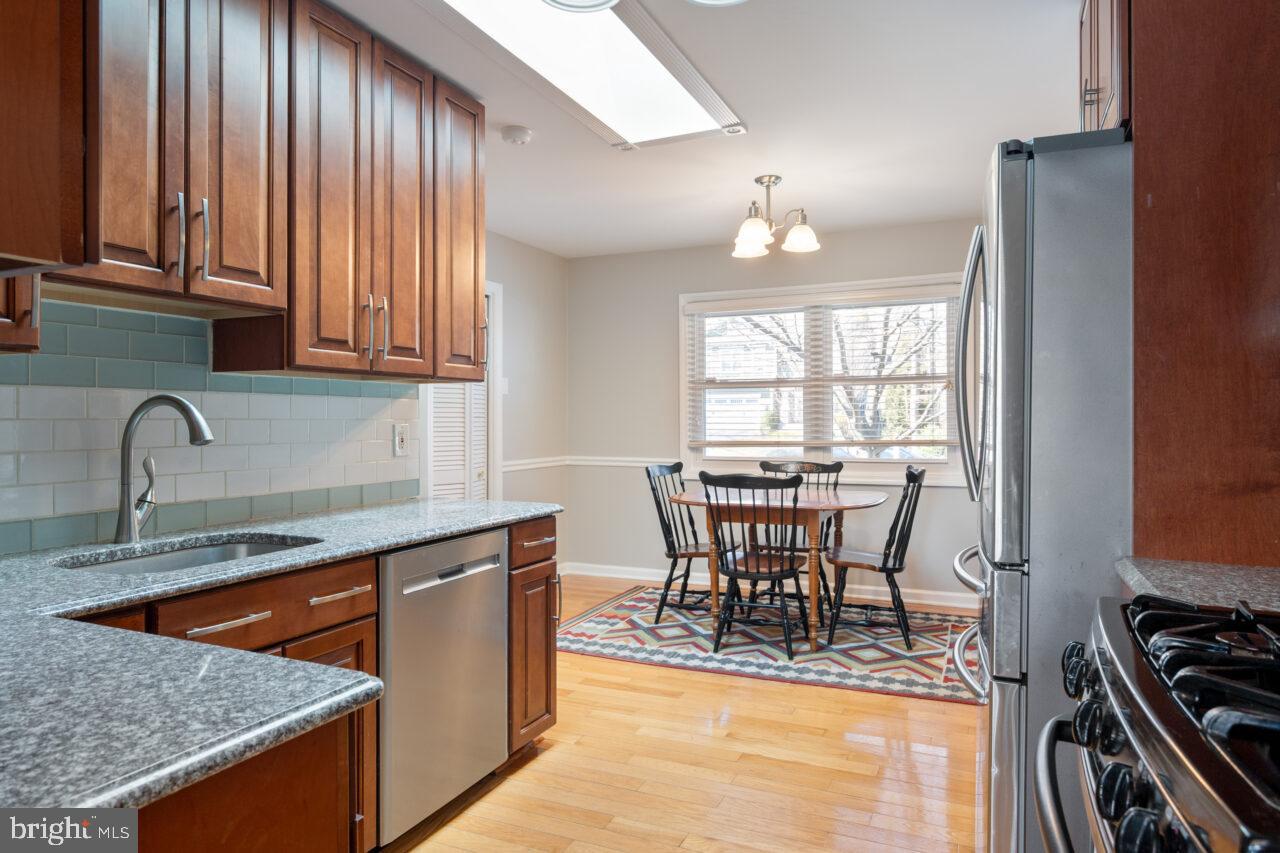 2405 Cedar Lane Vienna, VA 22180 - Photo 36 of 56 a view of a kitchen with dining table and chairs