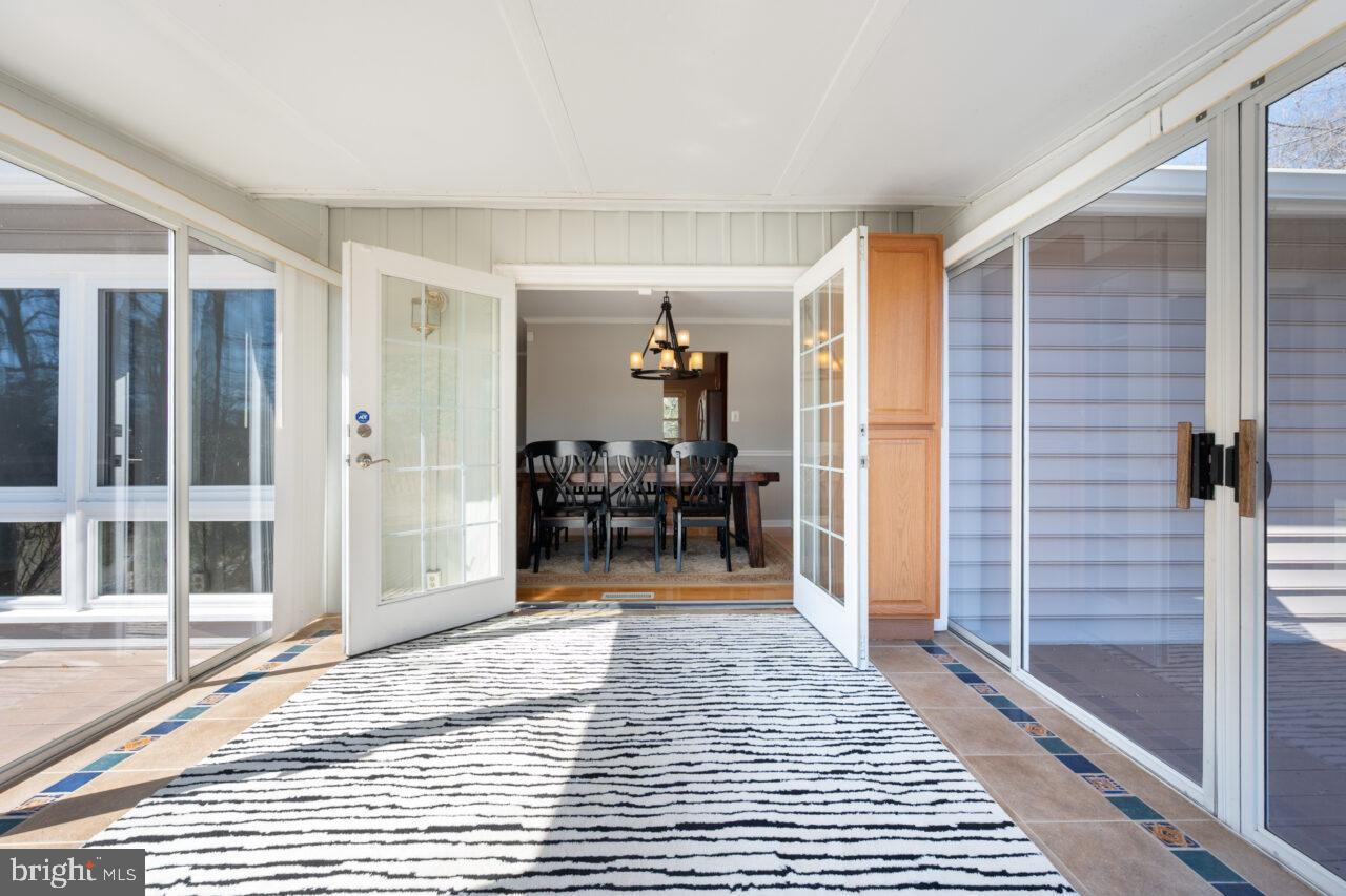 2405 Cedar Lane Vienna, VA 22180 - Photo 46 of 56 a view of a hallway with a livingroom and dining room and wooden floor